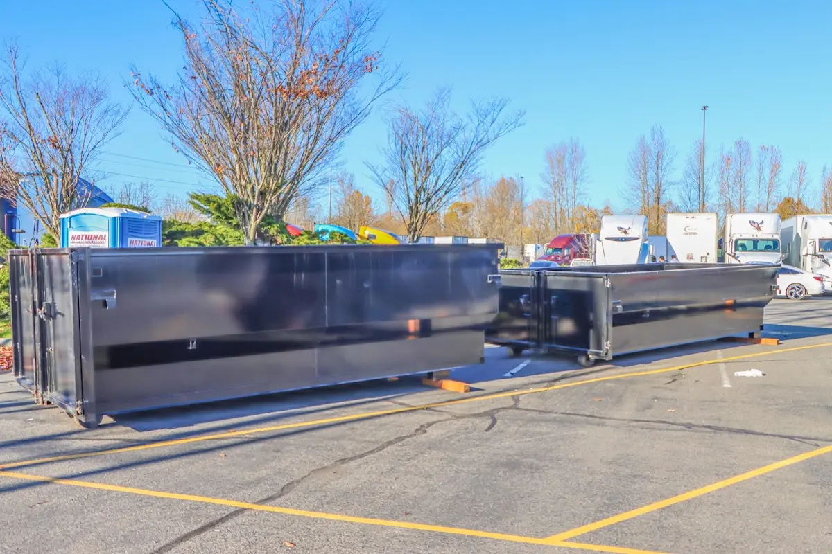 Professional dumpster rental service with roll-off container on residential driveway in Cloverleaf